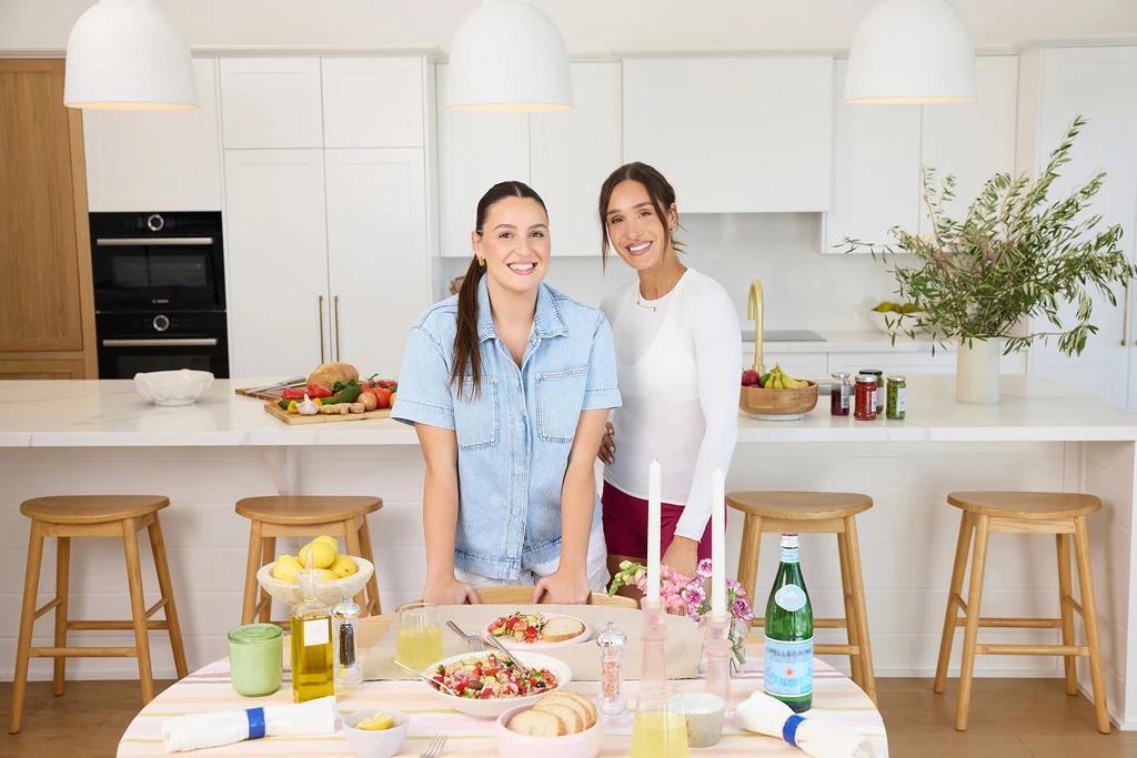 Leah and Kayla Itsines in the kitchen