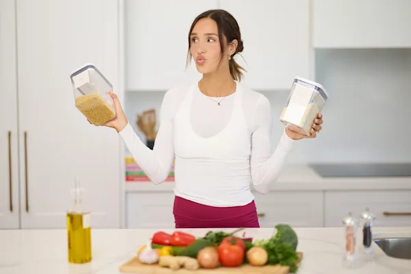Kayla Itsines meal prepping in kitchen