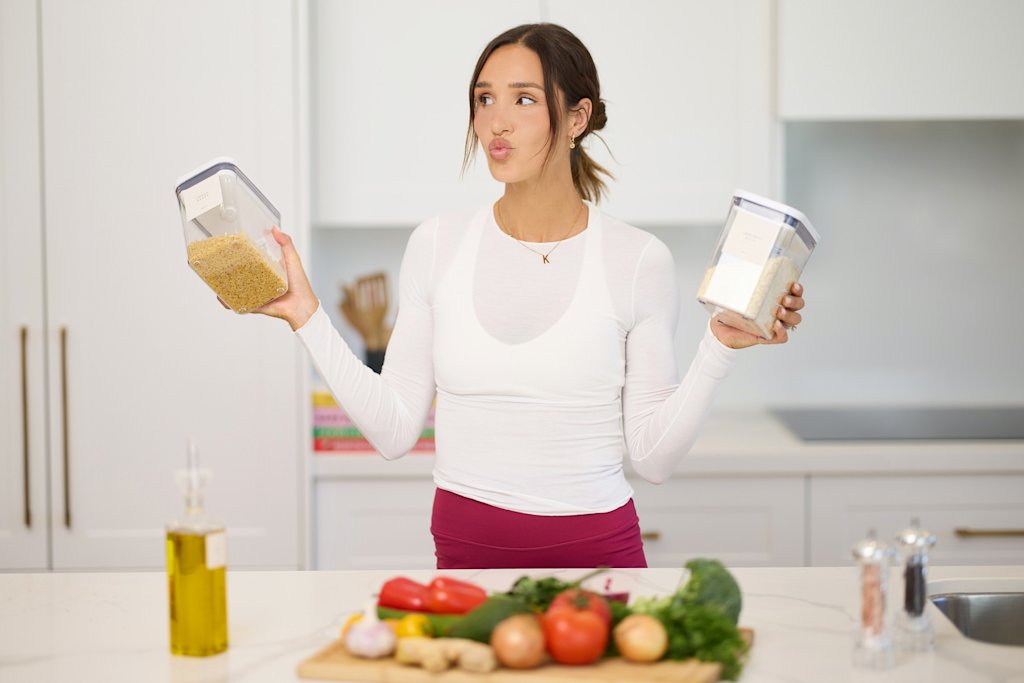 Kayla Itsines meal prepping in kitchen