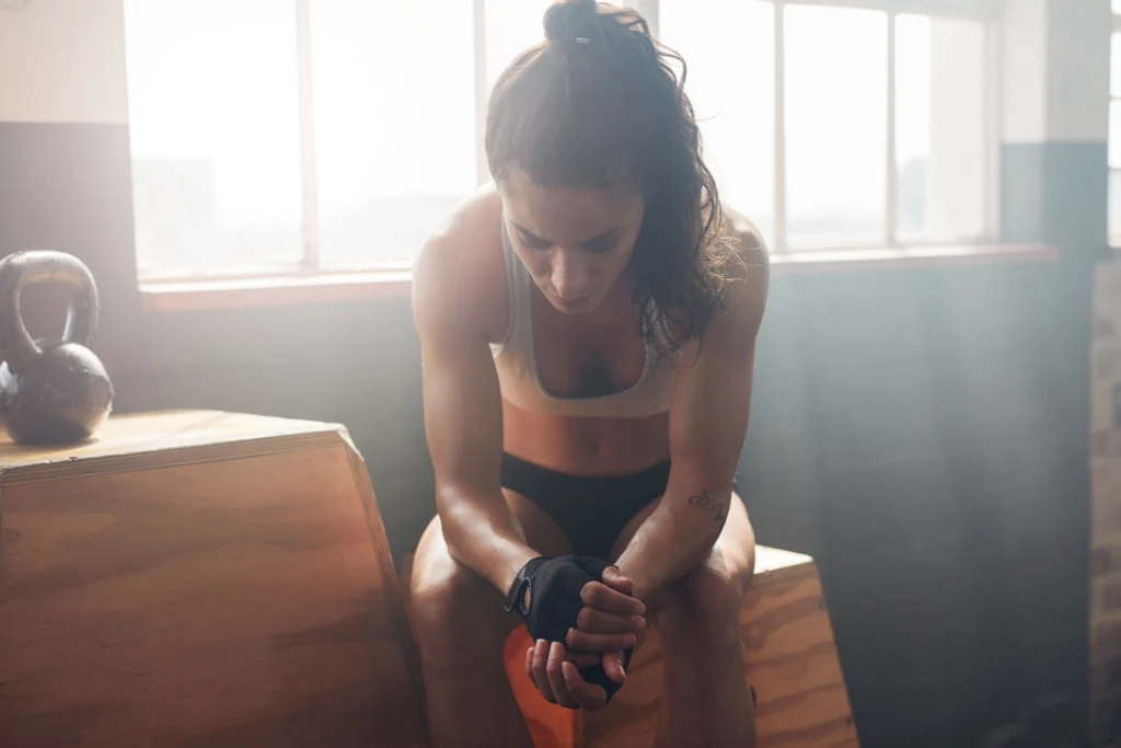 Young woman sitting on box exercise