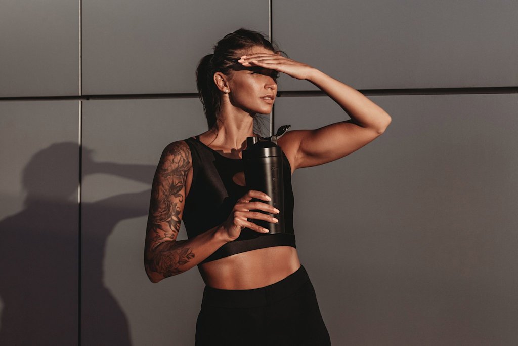 Woman standing with shaker 