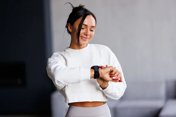 Woman looking at fitness watch