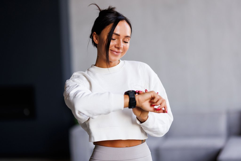 Woman looking at fitness watch