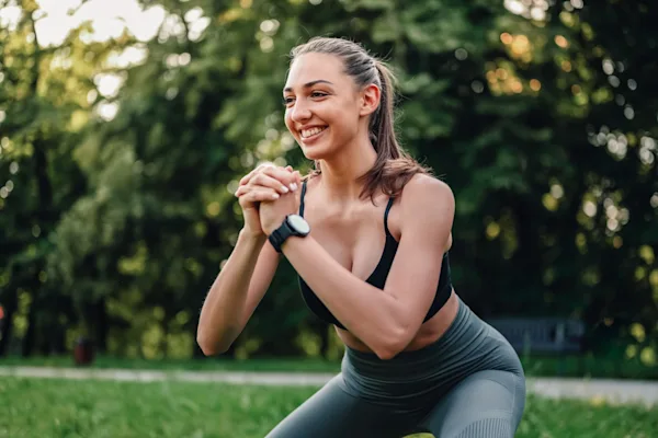 Woman smiling doing squat