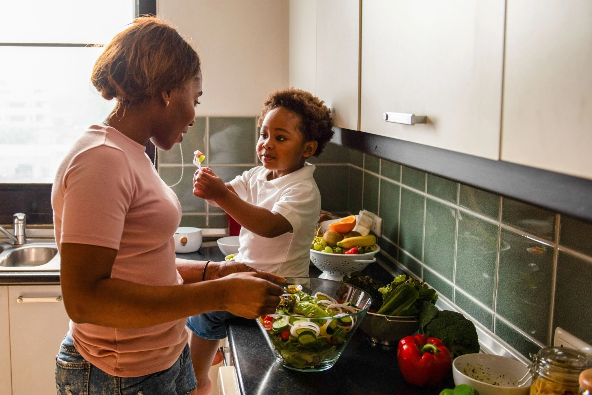 Woman in kitchen with child